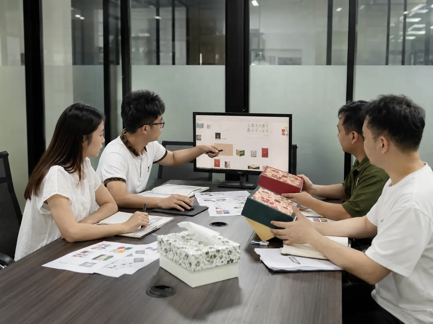 Cosmetic packaging supplier design team reviewing custom box samples